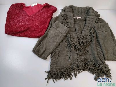 two sweaters that are sitting next to each other on a table