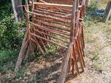 a pile of wooden sticks sitting in the grass