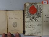 someone is holding a book with a red rose on it