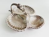 a silver plate with two leaves on it