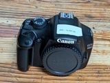 a camera sitting on a wooden table with a lens on it