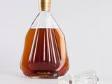 an image of a bottle of brandy next to a shot glass