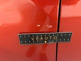 a close up of a sticker on a red car