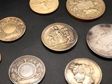 a lot of coins that are on the table