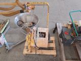 a machine that is sitting on a pallet next to other items