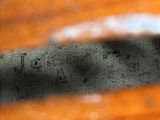 an image of a close up of a piece of wood with writing on it