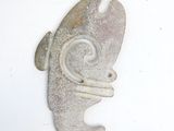 a fish shaped object on a white surface