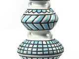 a blue and white vase sitting on top of a white table