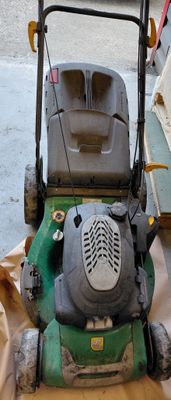 a lawn mower that is sitting on the ground