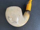 a pipe with a yellow handle sitting on a table