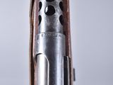 a close up of a gun with a leather case