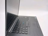 a black laptop computer sitting on a white surface