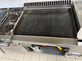 a grill with a grill top on it in a kitchen