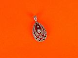 a close up of a diamond pendant on an orange background