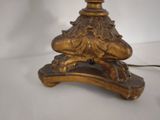 a gold lamp that is on a white table