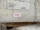 a pile of white pillows sitting on top of a wooden pallet