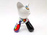 a white cat figurine with a colorful design on it ' s legs