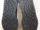 the soles of a pair of black shoes on a white surface