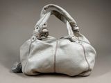an image of a white purse with a tassel on it