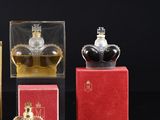 three bottles of perfume sitting on top of a table next to each other
