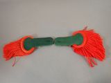 pair of orange and green tassels on a white surface