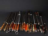 several different types of pens are lined up on a black surface