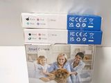 three boxes of pet products sitting on a table