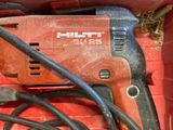 a red box with a drill and a cord in it
