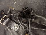 a black purse with a metal buckle on it