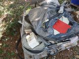 a pile of luggage sitting on the ground in the grass