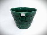 a green planter that has a tag on it