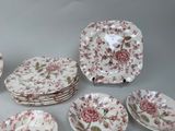 many plates and bowls that are sitting on a table