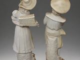 two figurines that are standing next to each other
