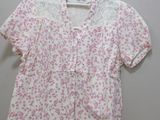 pink and white blouse with floral print on the front