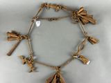 an image of a necklace made out of sticks and other items