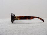 the glasses are made of tortoises and have a gold emblem on them