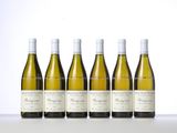 six bottles of white wine lined up on a table