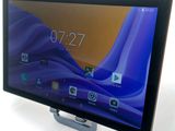 a close up of a tablet computer on a stand on a white surface