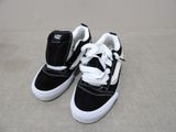 black and white sneakers with white laces on them on a carpet