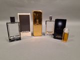 several different perfume bottles are lined up on a white surface