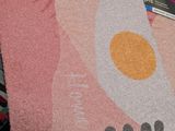 a pink rug with an egg on top of it