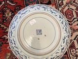 a bowl and a plate on a rug on the floor