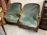 two green chairs sitting next to each other in a room