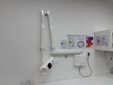 a bathroom with a toilet, sink, and shower stall