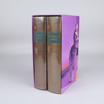 two books in a purple box on a white surface