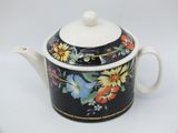 a close up of a teapot with a flower design on it