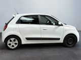 a picture of a small white car parked in a parking lot