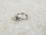 a close up of a silver ring with a skull on it
