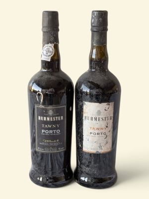 two bottles of wine sitting next to each other on a table