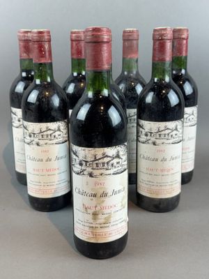 four bottles of wine are lined up on a table